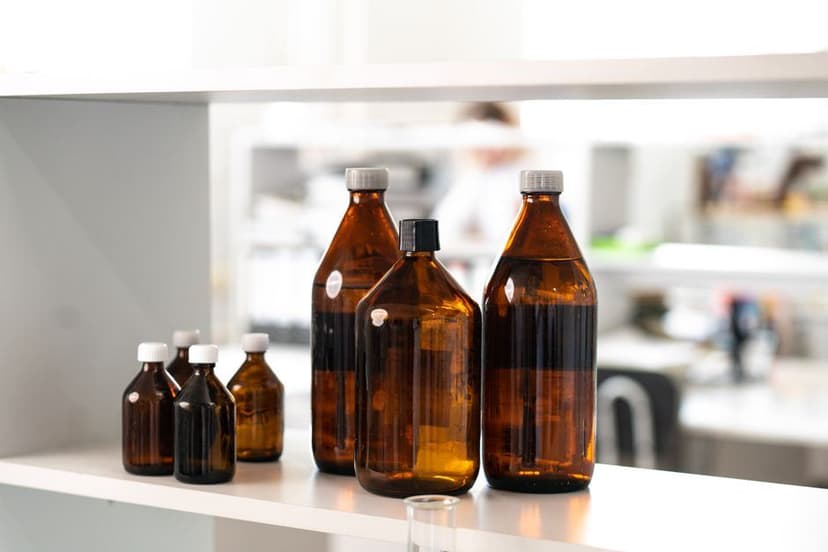 Bruine glazen medicijnflesjes op een plank in een laboratorium of apotheek.